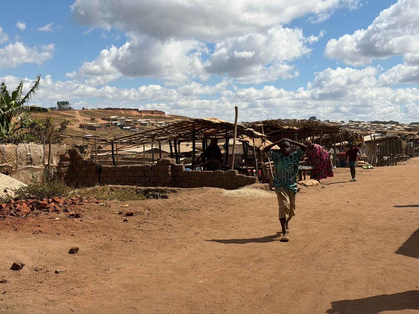 Open-air market stalls along a road in Dzaleka