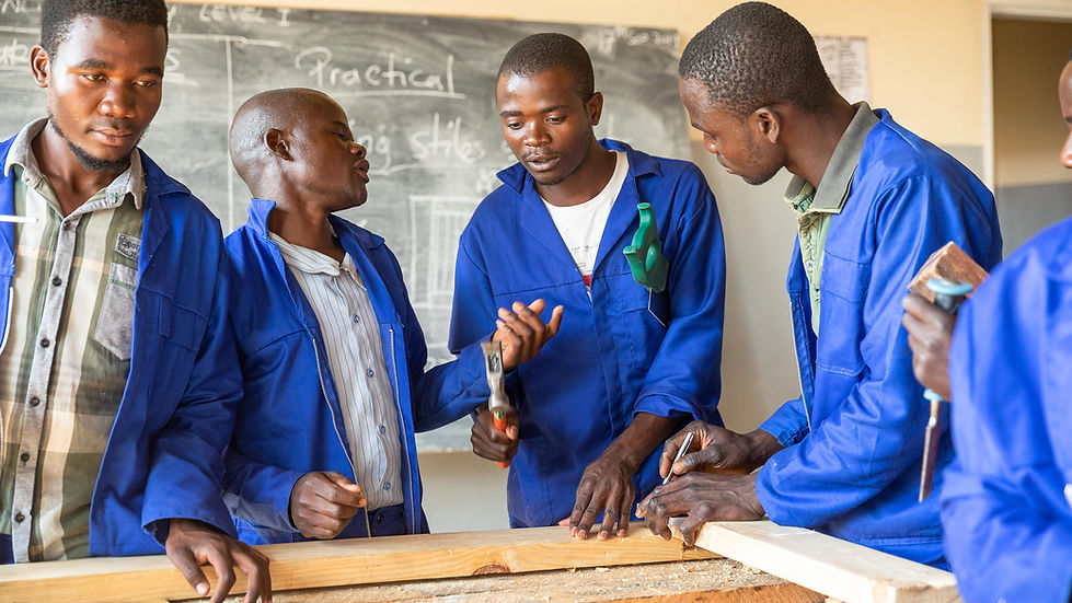 Carpentry trainees working at a bench during vocational training near Dzaleka
