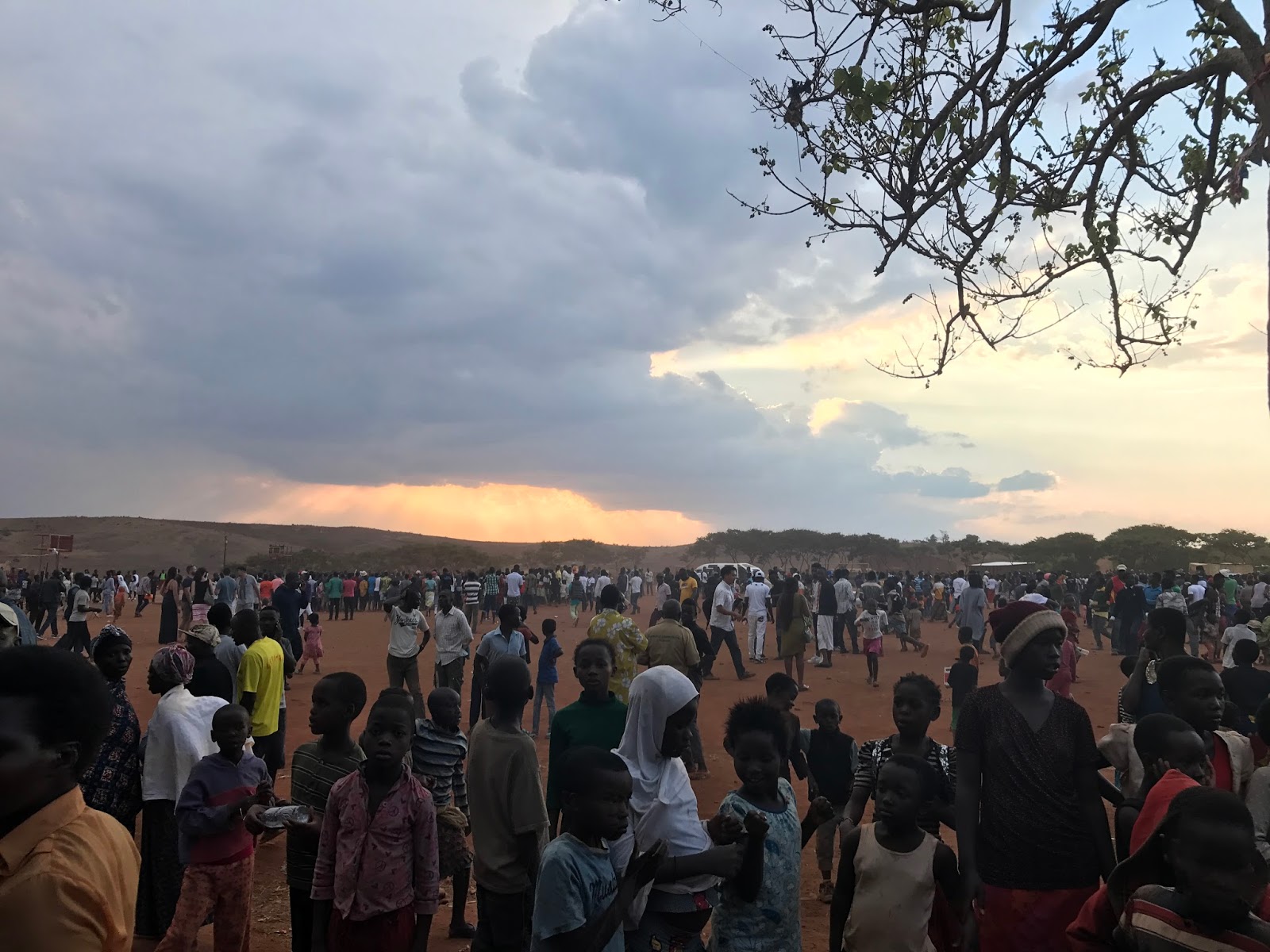 The crowd spreads back across the field as evening settles over the festival grounds.